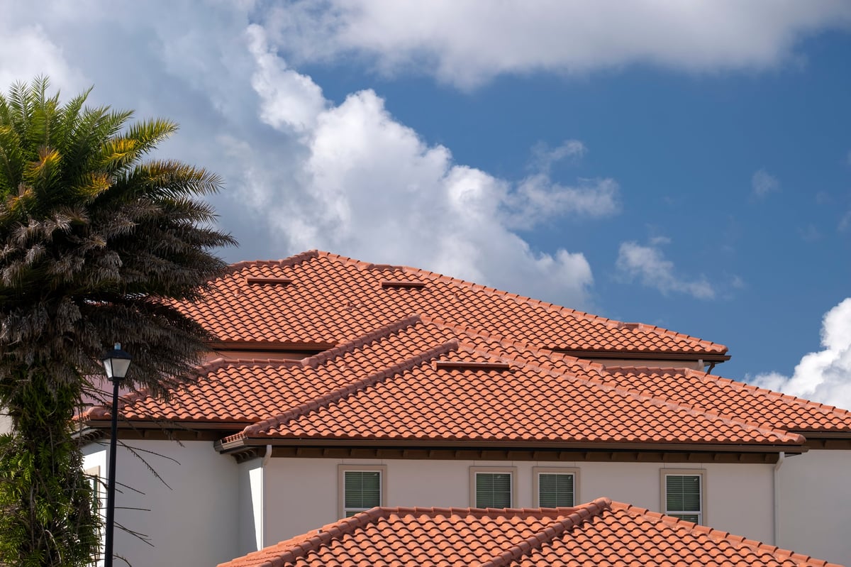 Closeup of premium clay tile roof on luxury Arizona home, showcasing authentic terracotta craftsmanship at sunset