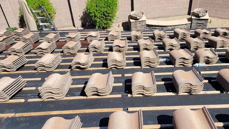 Aerial view of terracotta roof tiles arranged on wooden framework during construction or repair of a building roof